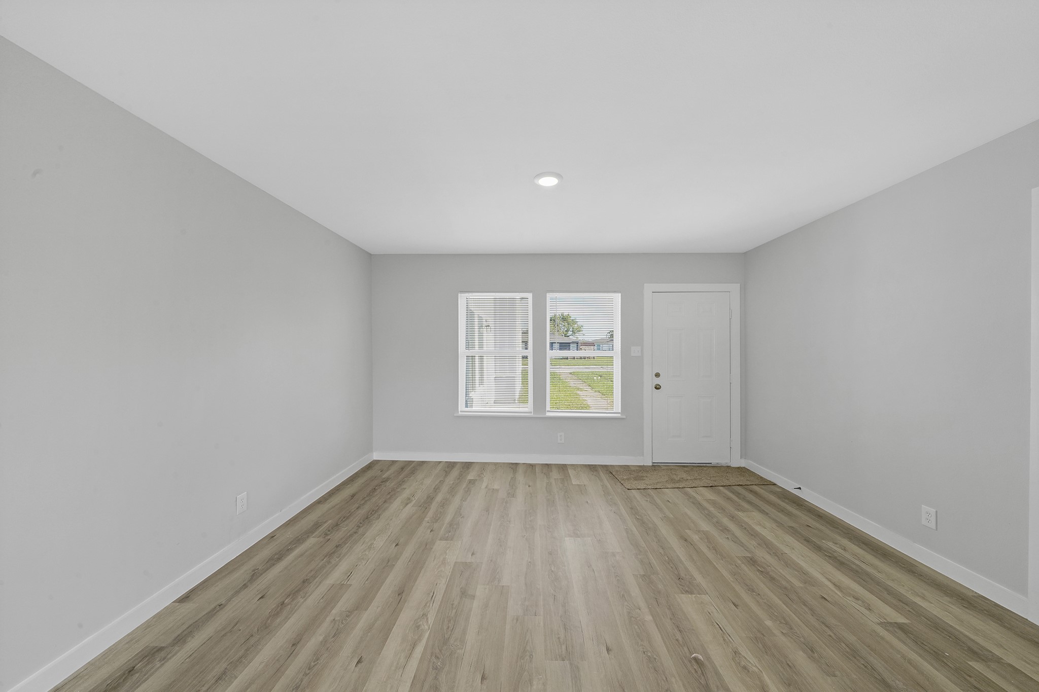 1753 West 6th Street Freeport, TX 77541 - Photo 5 of 20 wooden floor in an empty room with a window