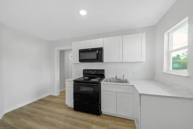 a kitchen with a stove and a microwave