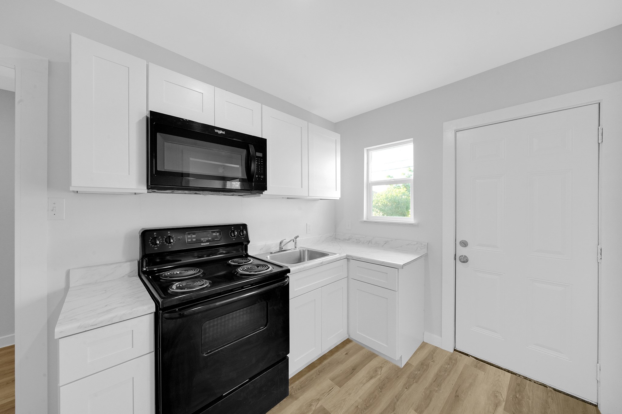 1753 West 6th Street Freeport, TX 77541 - Photo 8 of 20 a kitchen with a stove and a microwave
