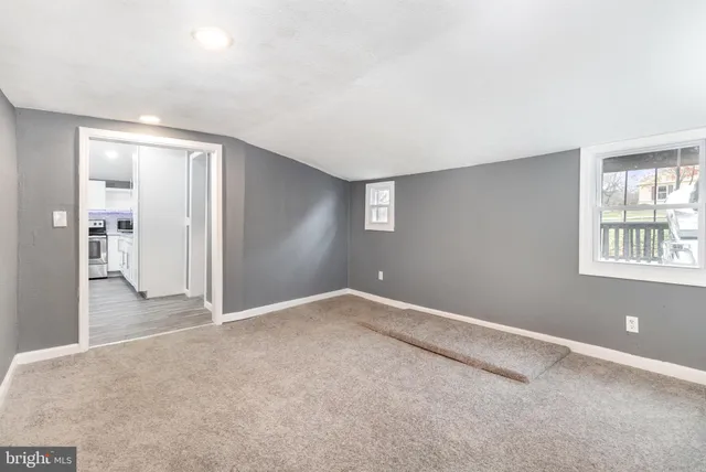 an empty room with windows and entrance