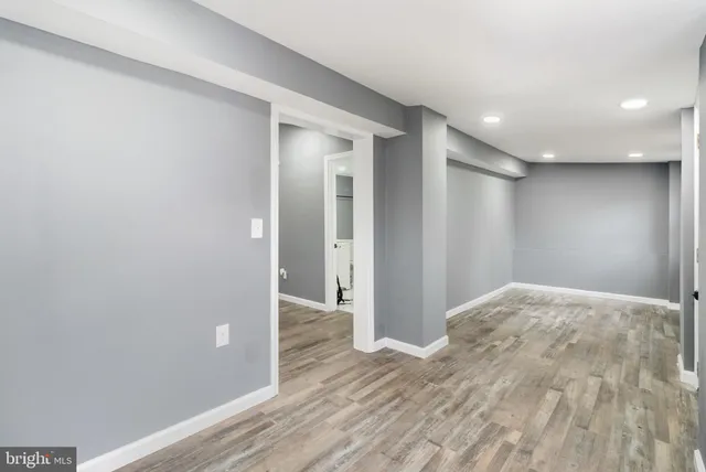 a view of hallway with wooden floor