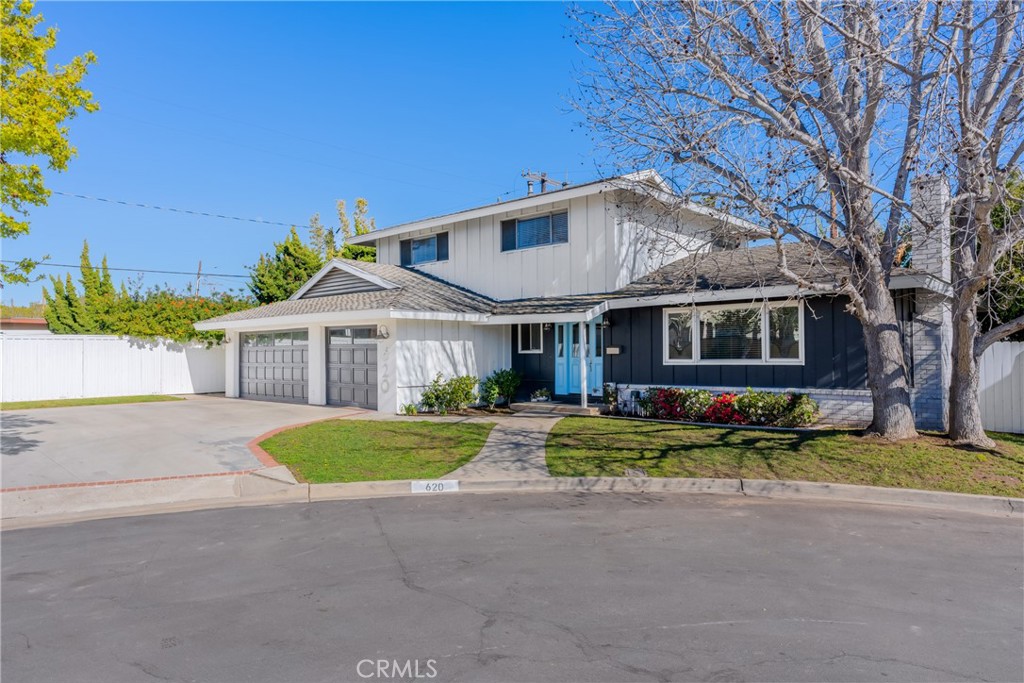 620 Michael Place Newport Beach, CA 92663 - Photo 1 of 30 a front view of a house with a yard and garage