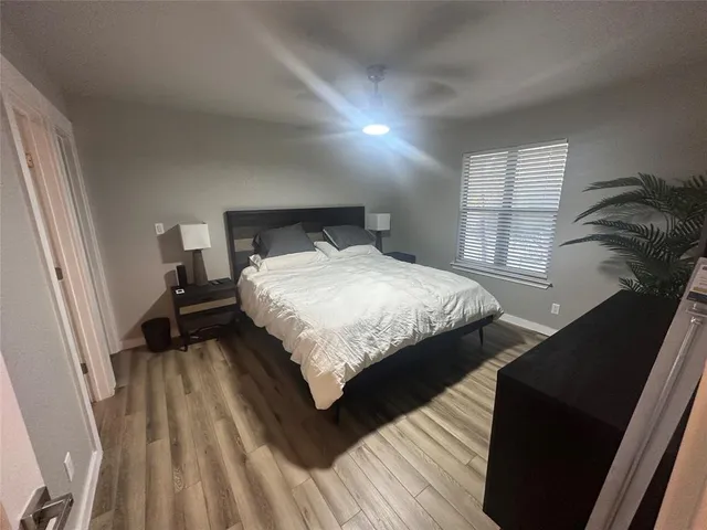 a bedroom with a bed and wooden floor
