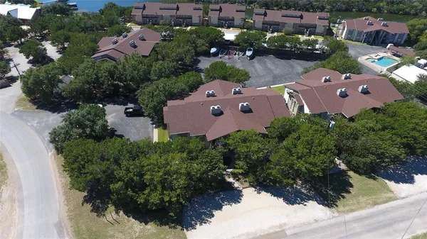an aerial view of a house with yard