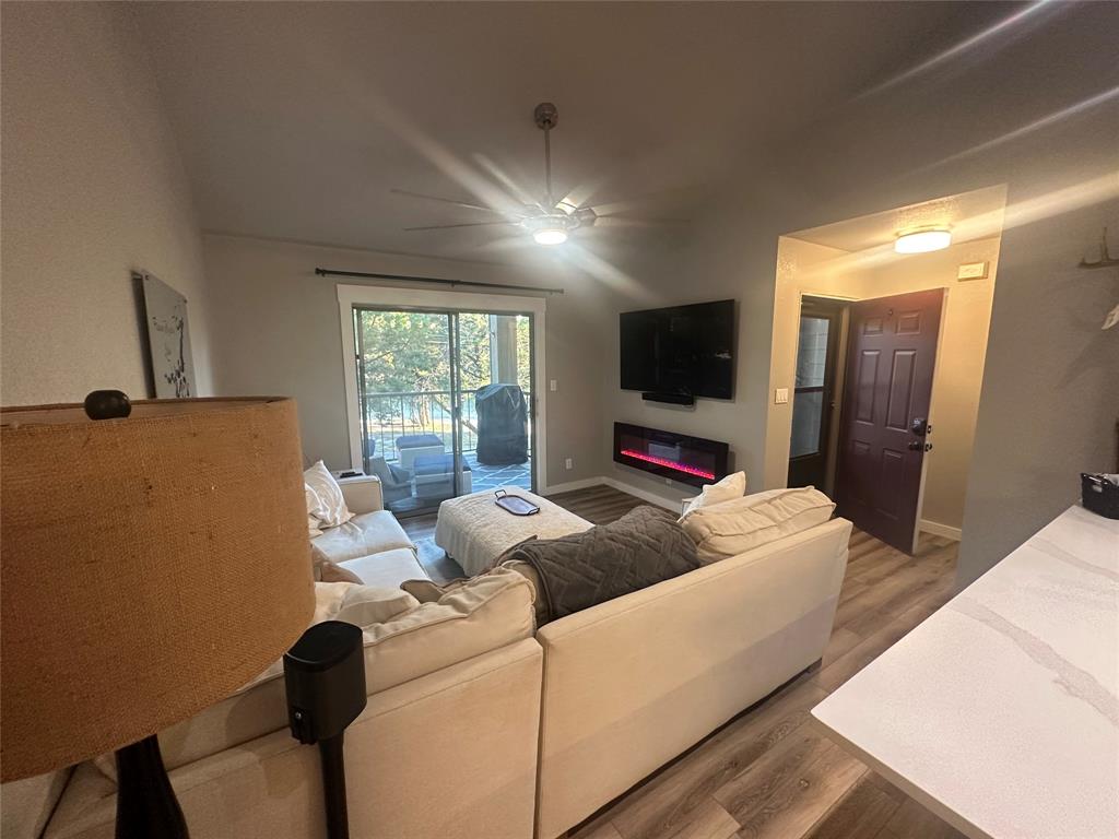 3059 Hells Gate Loop, Unit 8 Strawn, TX 76475 - Photo 4 of 20 a living room with furniture and a flat screen tv