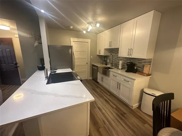 a kitchen with stainless steel appliances a stove refrigerator sink and cabinets