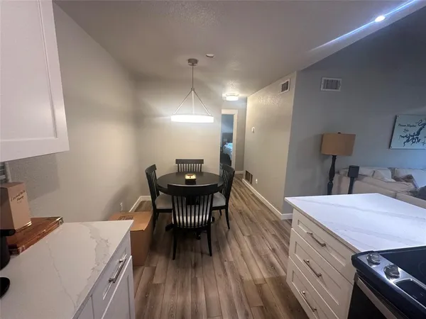 a view of a dining room with furniture and wooden floor