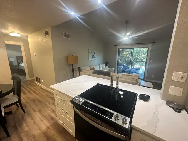 a kitchen with a stove a sink and a refrigerator