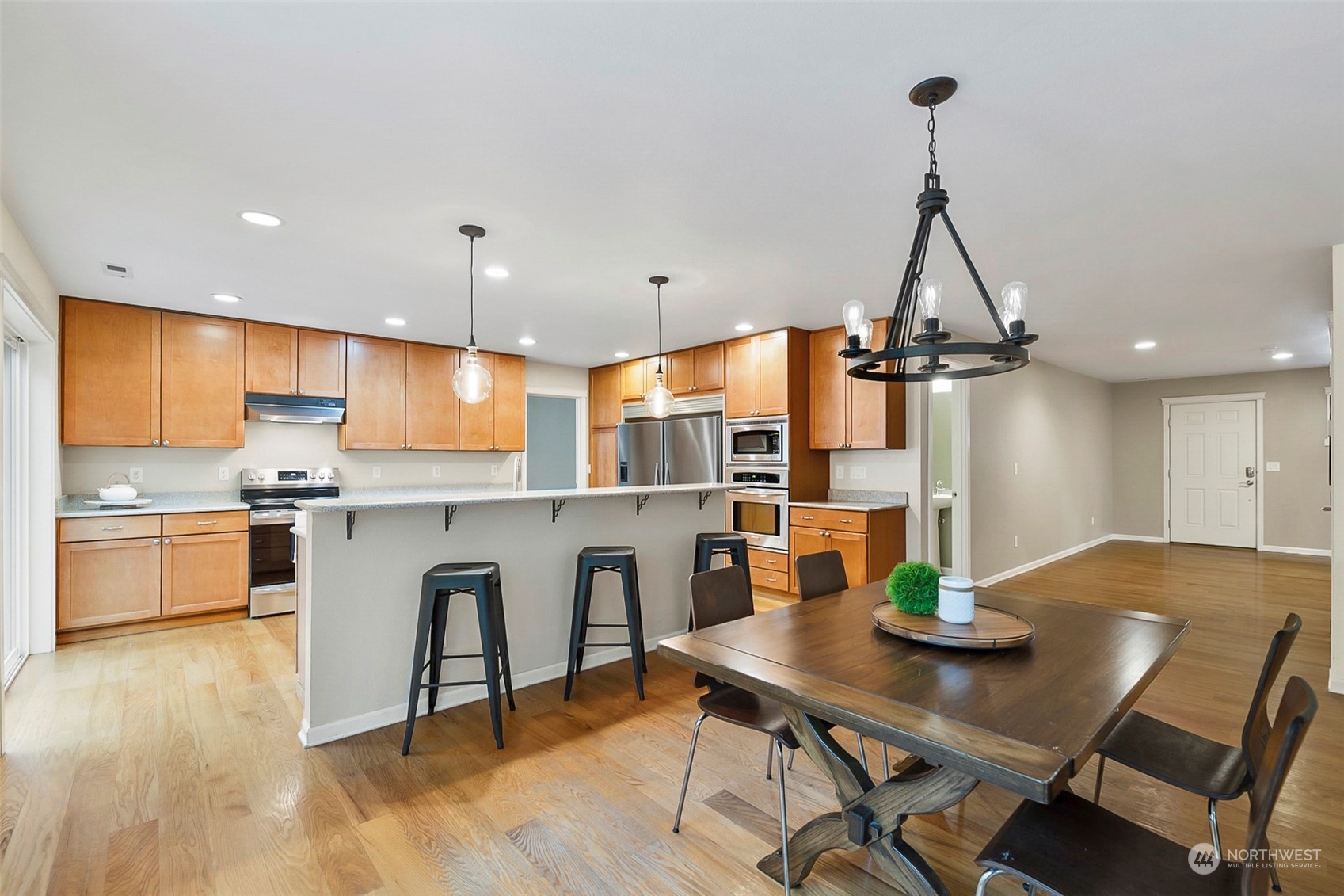 20227 Rustic View Road Southeast Monroe, WA 98272 - Photo 11 of 37 a kitchen with a table chairs and white cabinets