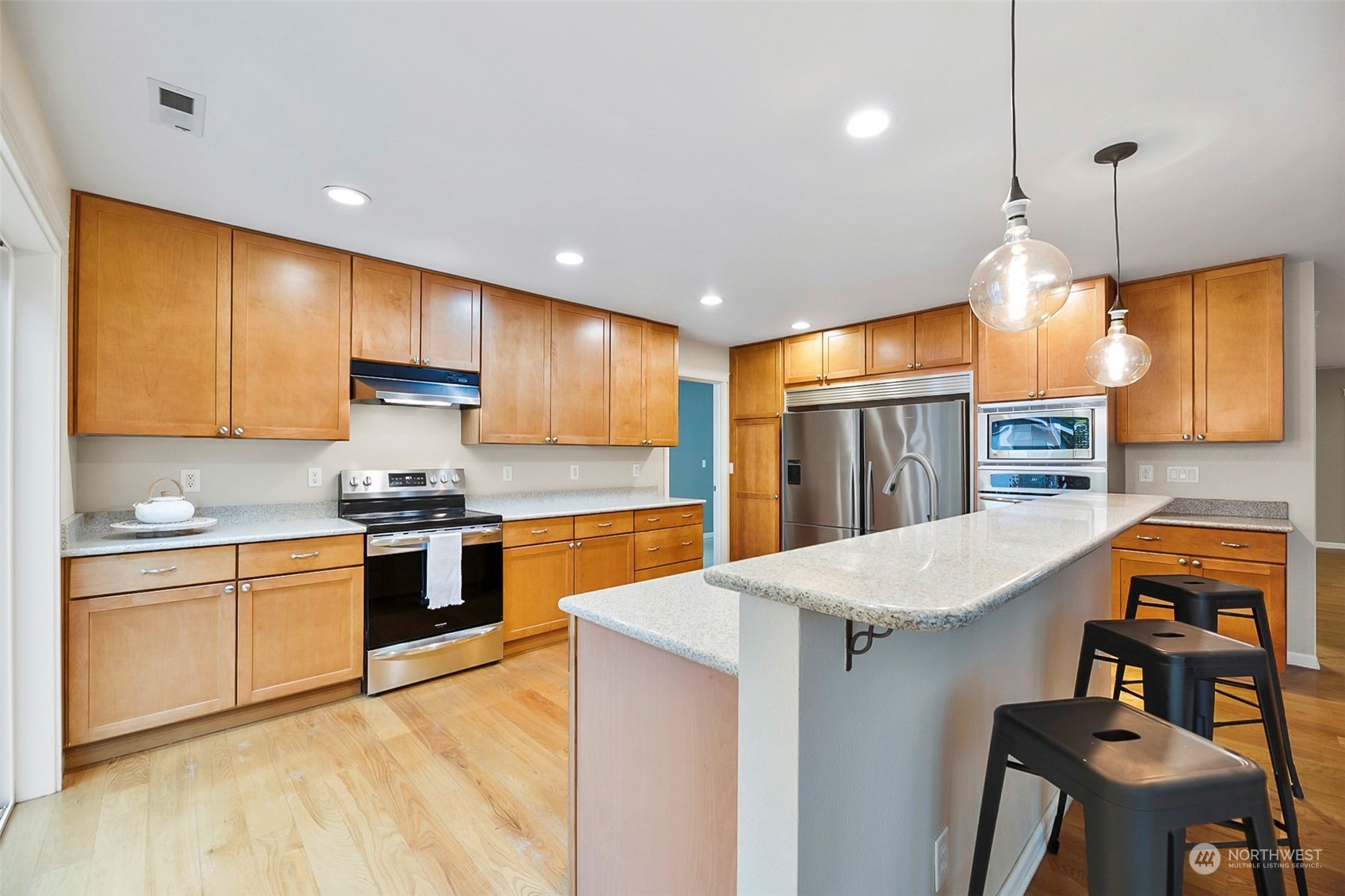 20227 Rustic View Road Southeast Monroe, WA 98272 - Photo 12 of 37 a kitchen with granite countertop a sink stove and refrigerator