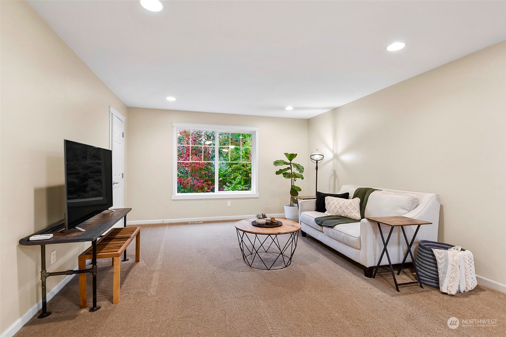 20227 Rustic View Road Southeast Monroe, WA 98272 - Photo 18 of 37 a living room with furniture a flat screen tv and a window
