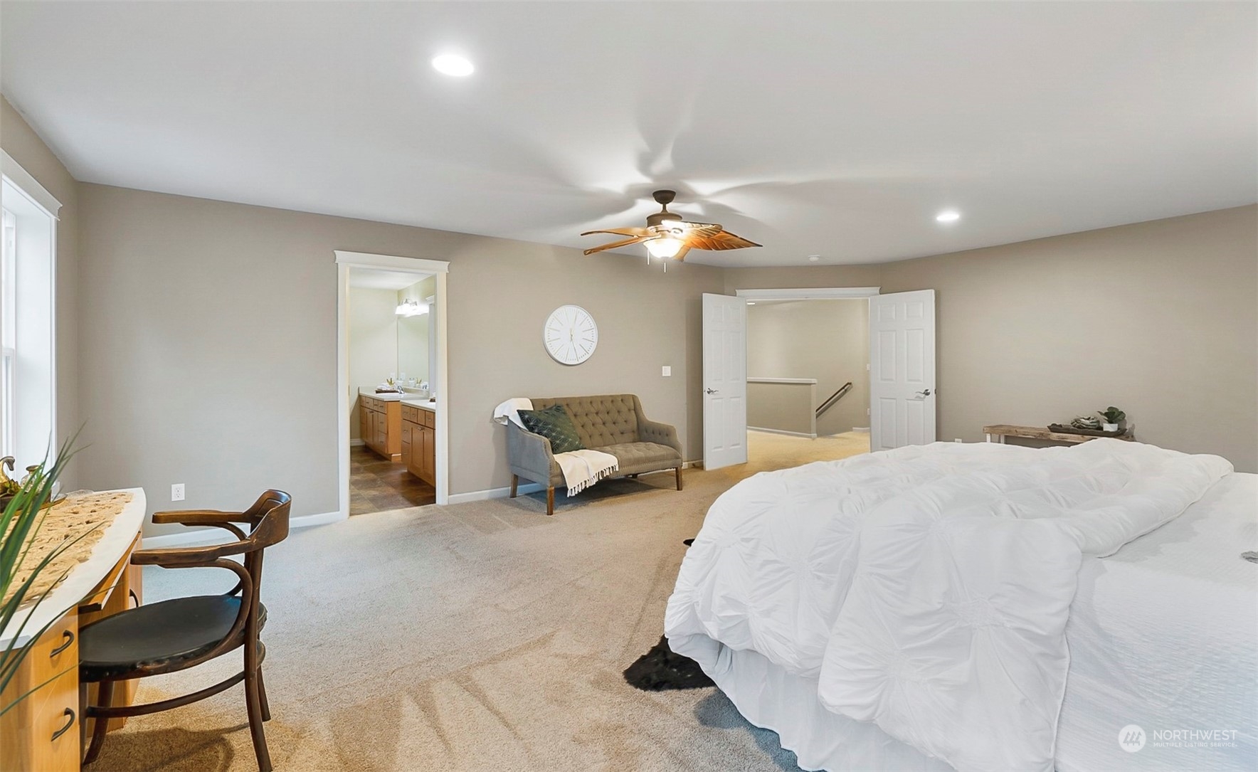 20227 Rustic View Road Southeast Monroe, WA 98272 - Photo 22 of 37 a spacious bedroom with a bed and a chandelier