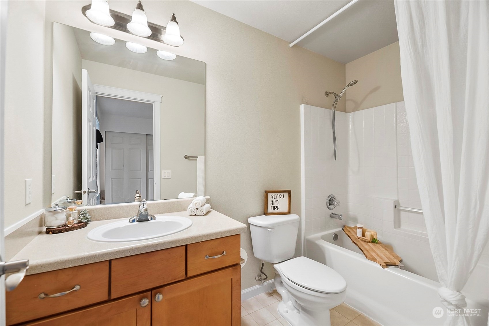 20227 Rustic View Road Southeast Monroe, WA 98272 - Photo 28 of 37 a bathroom with a sink a toilet a mirror and shower