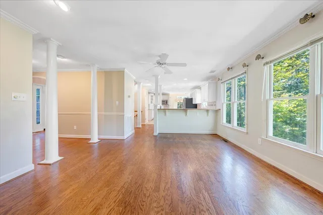 a view of a kitchen with wooden floor and a window