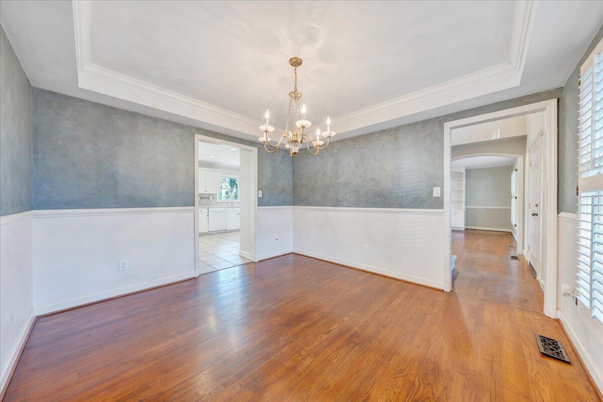 5539 Highfields Road Roanoke, VA 24018 - Photo 10 of 69 a view of a hallway with wooden floor and a chandelier