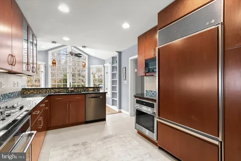 a living room with furniture and a flat screen tv with wooden floor