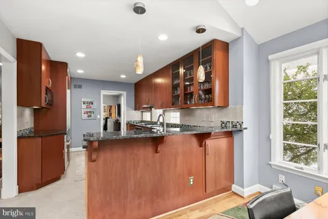 a living room with furniture a rug and a fireplace