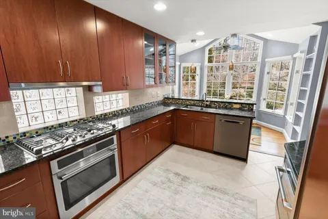 a living room with furniture a fireplace and a floor to ceiling window