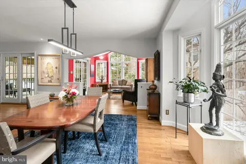 a living room with furniture a rug and a large window