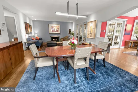 a living room with furniture and large wooden floor