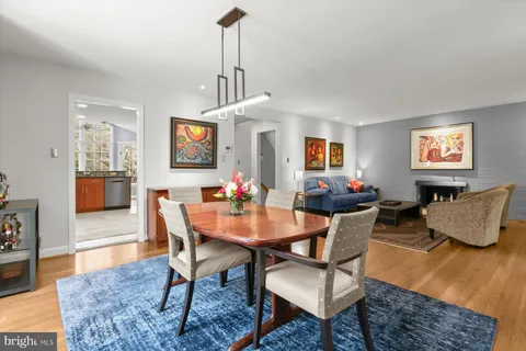 a view of a dining room with furniture large windows and wooden floor