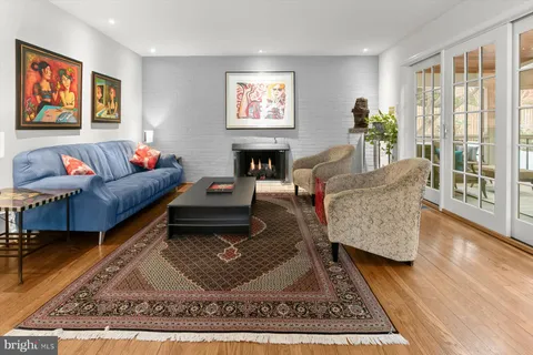 a bathroom with a granite countertop sink a toilet and a mirror