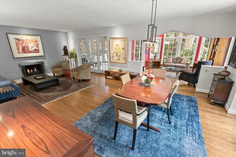 a bedroom with a bed a table and painting