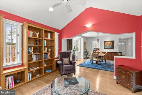 a living room with stainless steel appliances kitchen island granite countertop furniture and a window