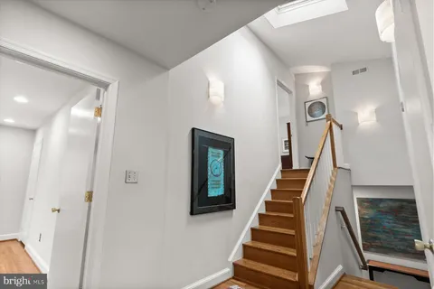 a bathroom with a toilet sink vanity and mirror