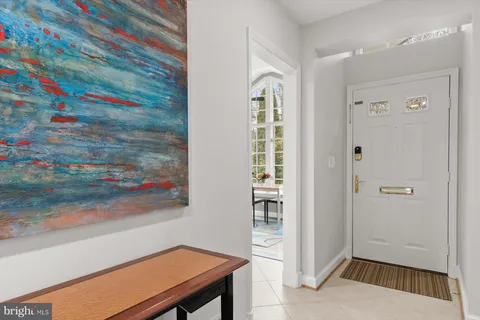 a kitchen with stainless steel appliances granite countertop a refrigerator a sink dishwasher a stove and a dining table with wooden floor