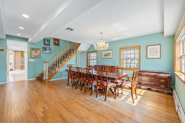 a dining room with furniture entryway and wooden floor