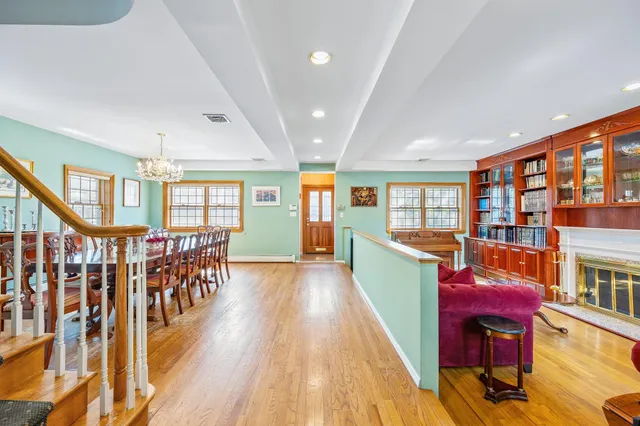 a dining room with furniture entryway and wooden floor