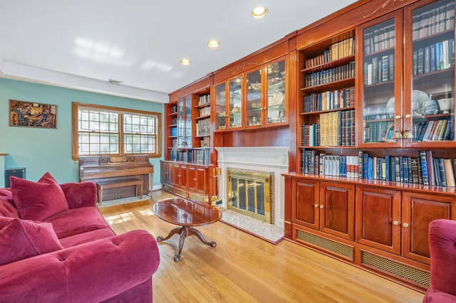 a living room with furniture fireplace and book shelf