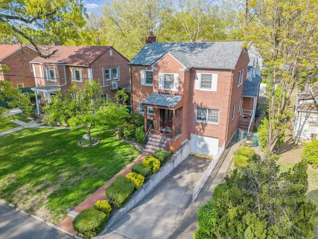 a front view of a house with a yard table and chairs