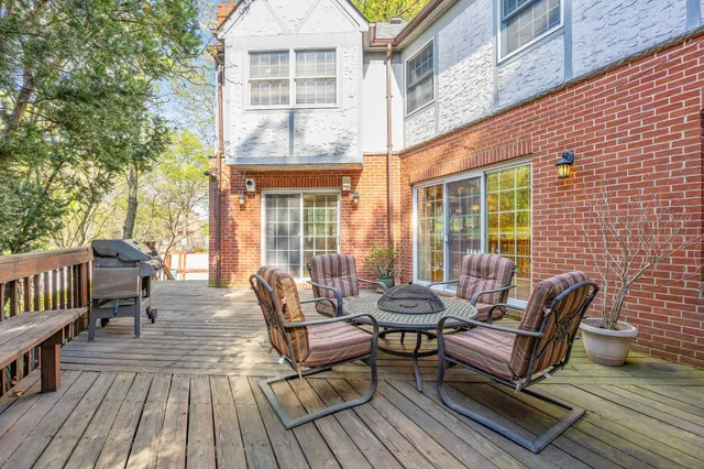 a view of a patio with table and chairs and wooden floor