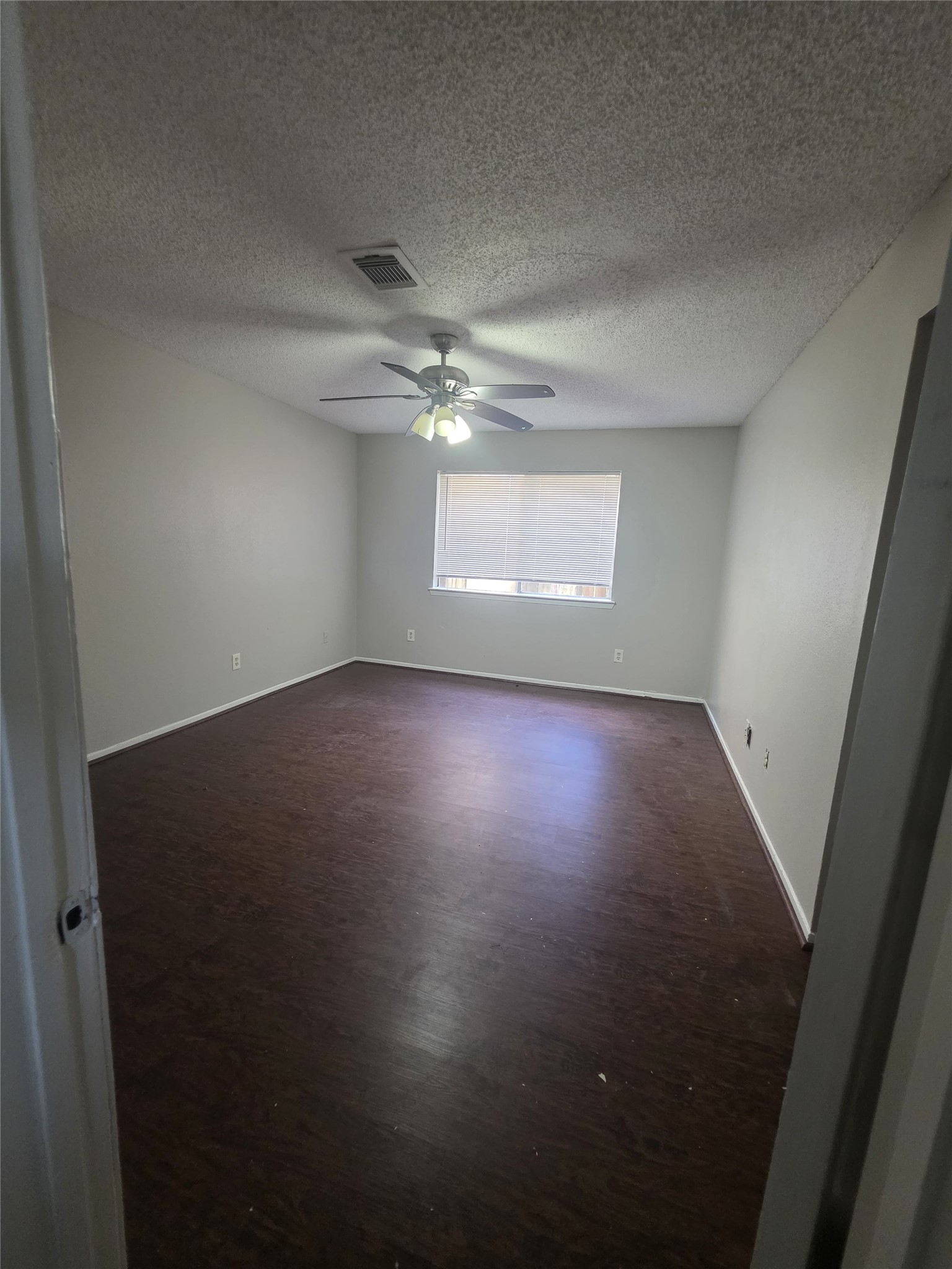23322 Dew Wood Lane Spring, TX 77373 - Photo 19 of 20 an empty room with windows and ceiling fan