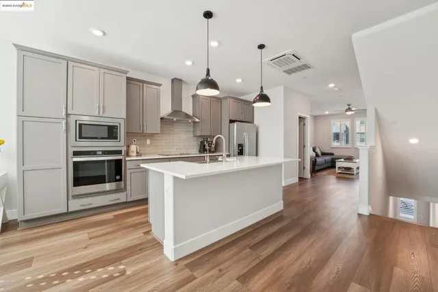 a kitchen with stainless steel appliances a stove microwave and cabinets