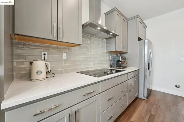 a kitchen with a sink a counter space and stainless steel appliances
