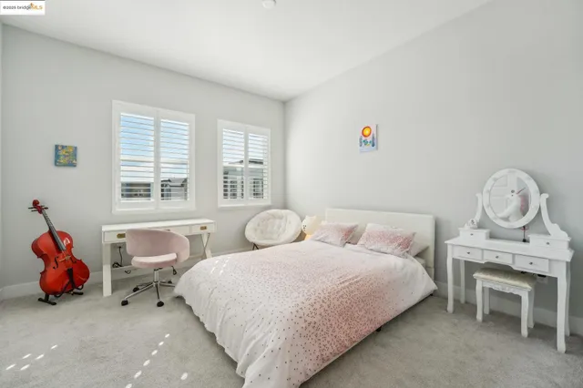 a bedroom with a bed and windows