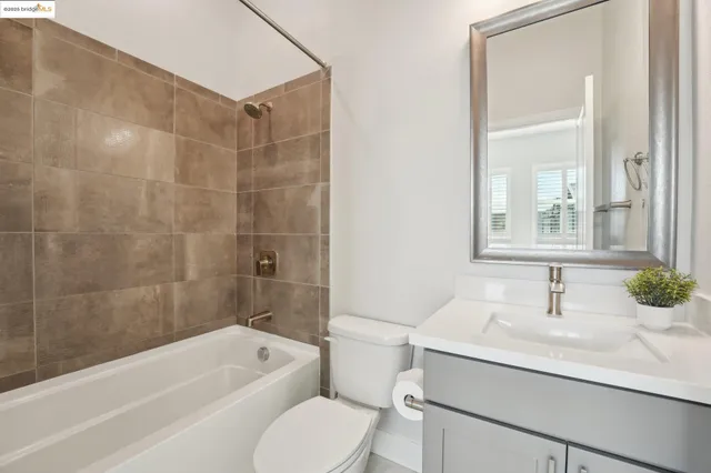 a bedroom with a bed potted plant with the view of kitchen