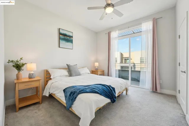a bedroom with a bed and a chandelier fan