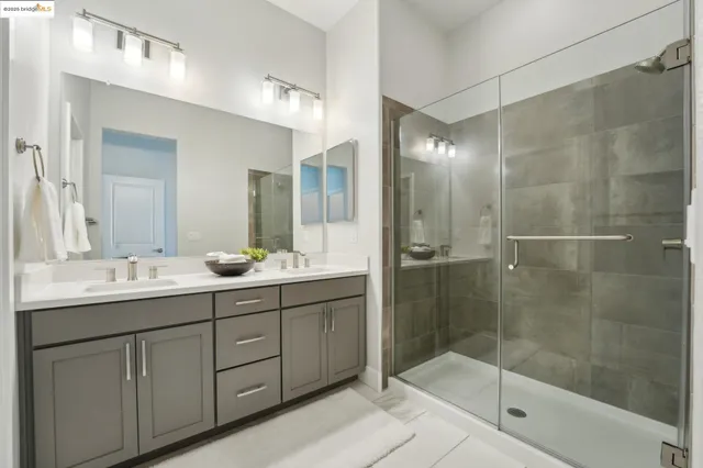 a bathroom with a shower sink and mirror