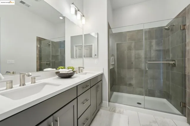 a bathroom with a double vanity sink toilet and a mirror