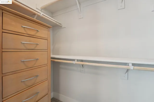 a bedroom with bed and a night stand