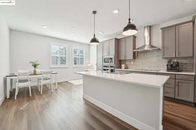 a kitchen with a sink appliances and cabinets
