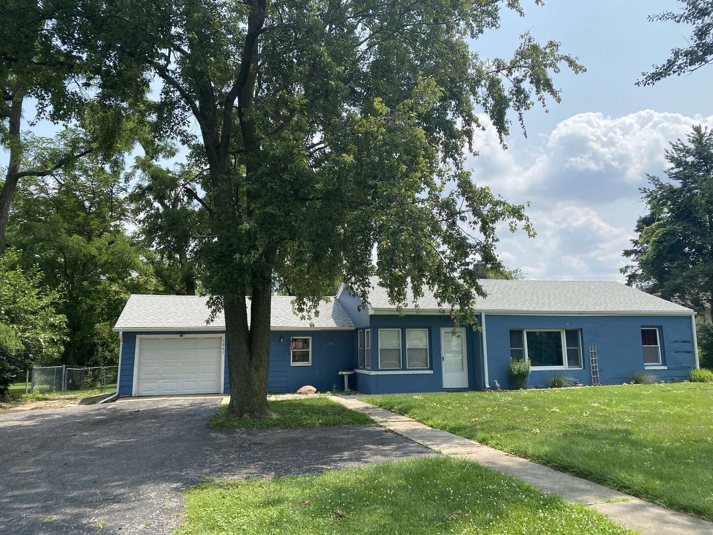 6845 Willow Springs Road Countryside, IL 60525 - Photo 1 of 16 a front view of a house with a garden and trees