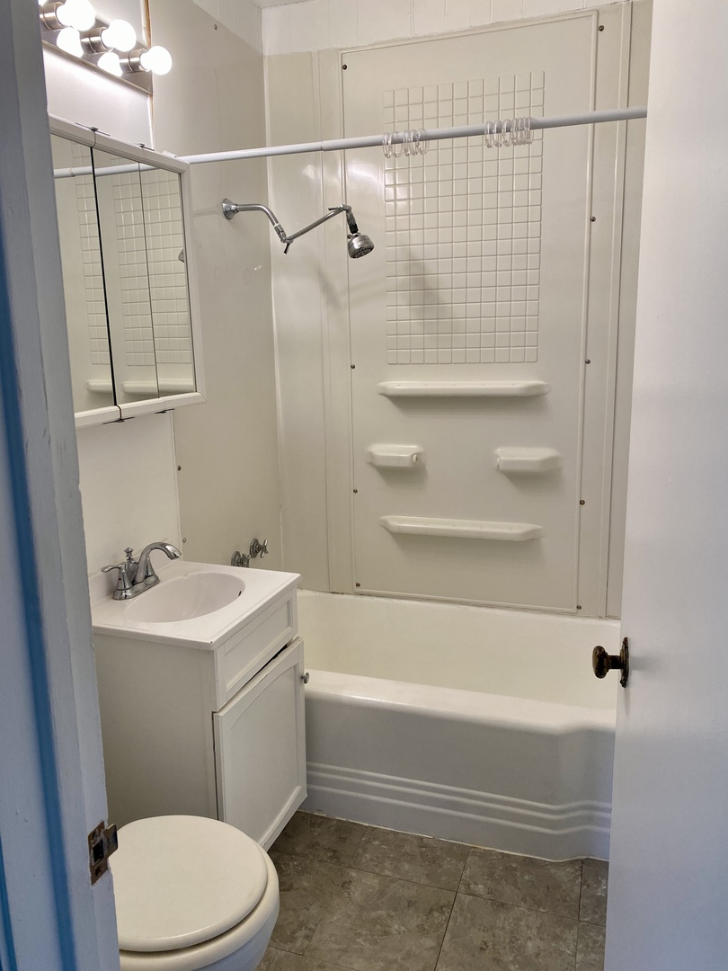 6845 Willow Springs Road Countryside, IL 60525 - Photo 12 of 16 a bathroom with a sink a toilet and shower