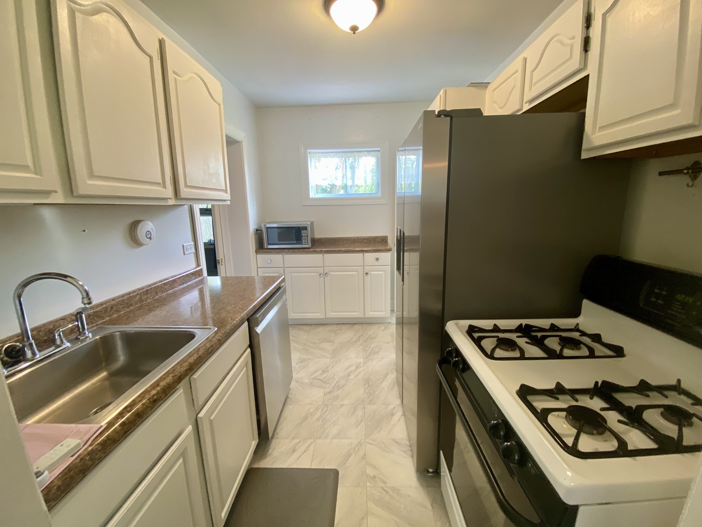 6845 Willow Springs Road Countryside, IL 60525 - Photo 7 of 16 a kitchen with stainless steel appliances granite countertop a sink stove and refrigerator