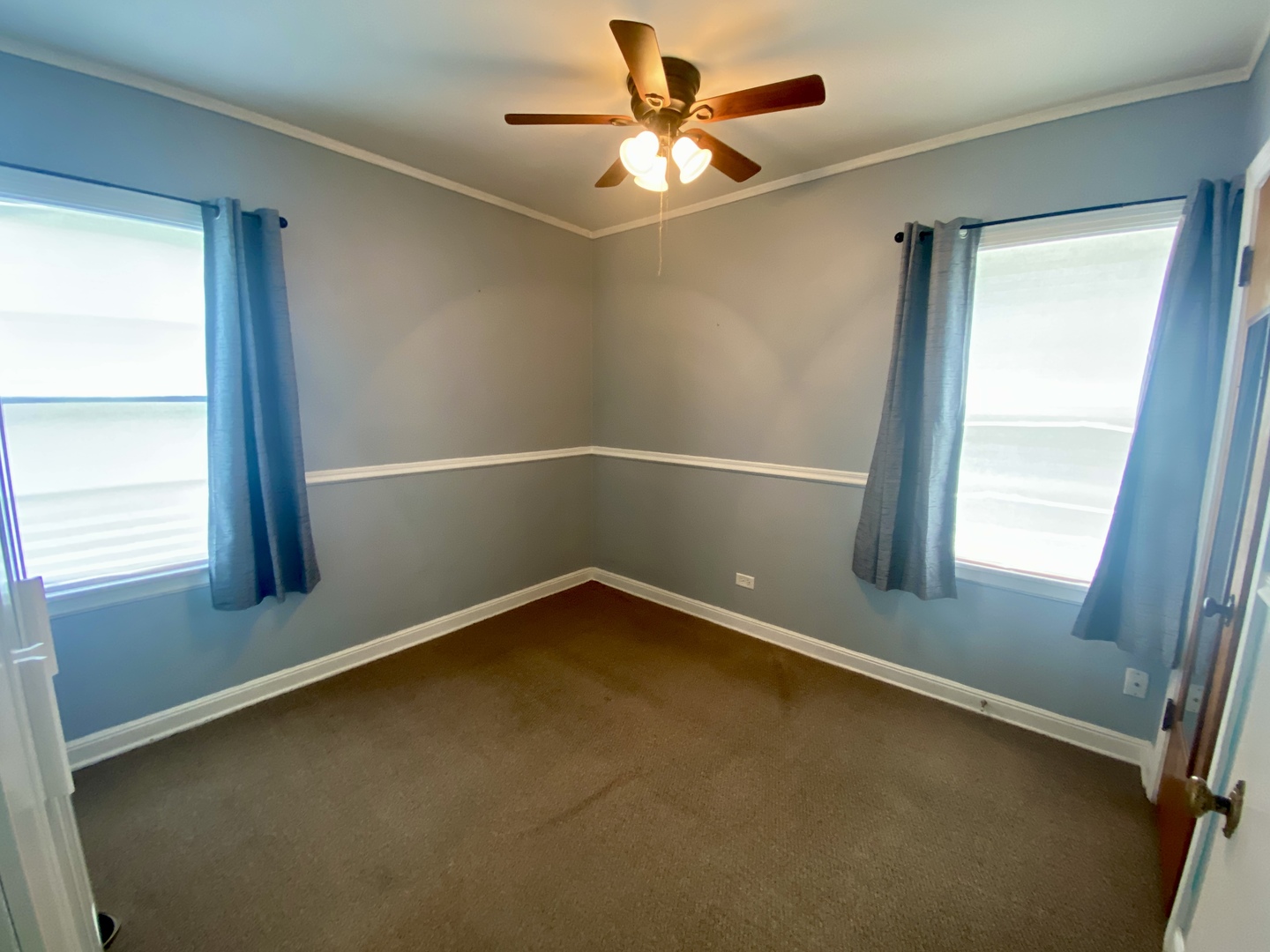6845 Willow Springs Road Countryside, IL 60525 - Photo 10 of 16 an empty room with a window and a fan