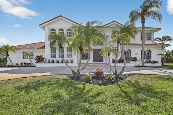 a front view of house with yard and green space